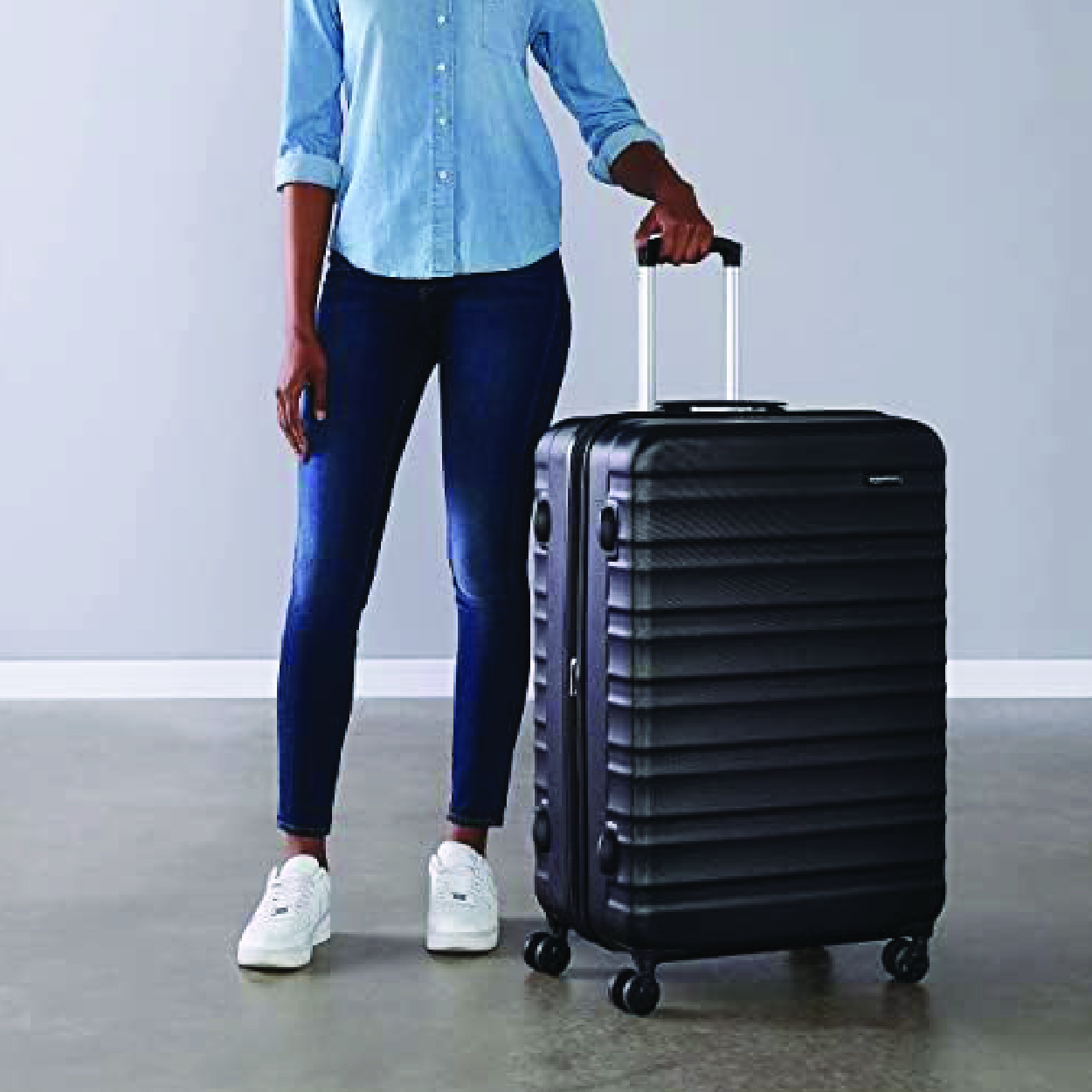 A black 28-inch hardside spinner luggage with four double spinner wheels, expandable design, and interior organizer, ideal for travel.